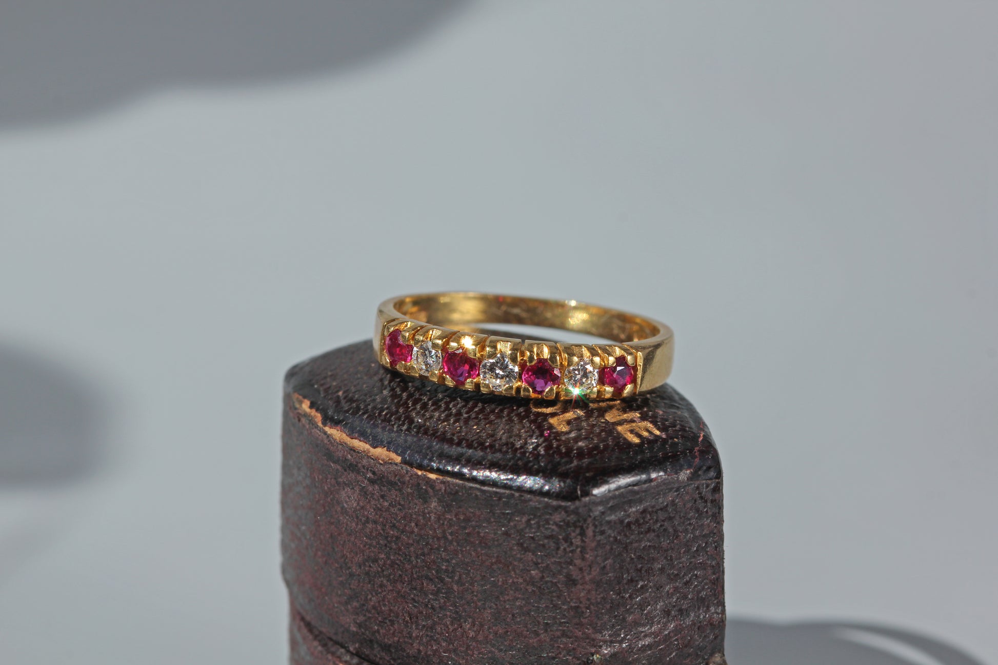 Vintage ruby and diamond half eternity band ring in 18ct gold on antique ring box