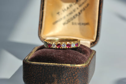 Vintage 18ct gold ruby and diamond half eternity ring on antique jewellery box 