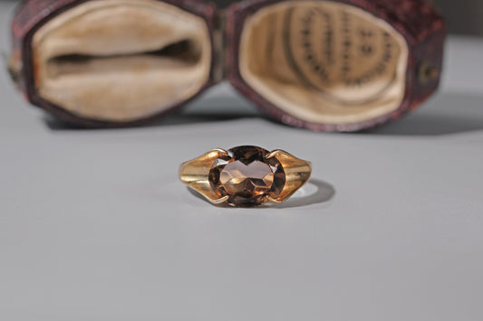 Vintage smoky quartz ring in 9ct gold on grey background
